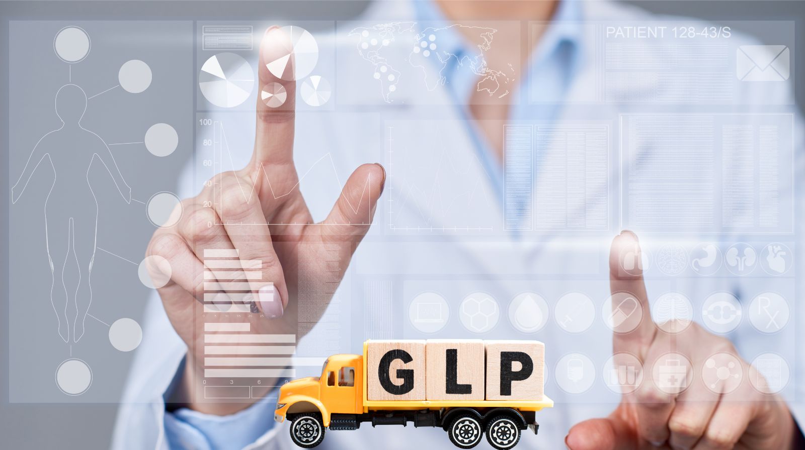 Doctor in lab coat interacting with digital patient data and charts while pointing to a toy truck labeled "GLP" representing GLP-1 medication delivery or logistics.